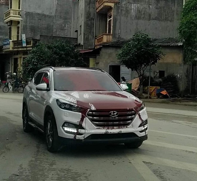 Hình ảnh sơn xe ô tô: Chiếc Hyundai màu trắng bị xịt sơn đỏ lên nắp capo và thân xe